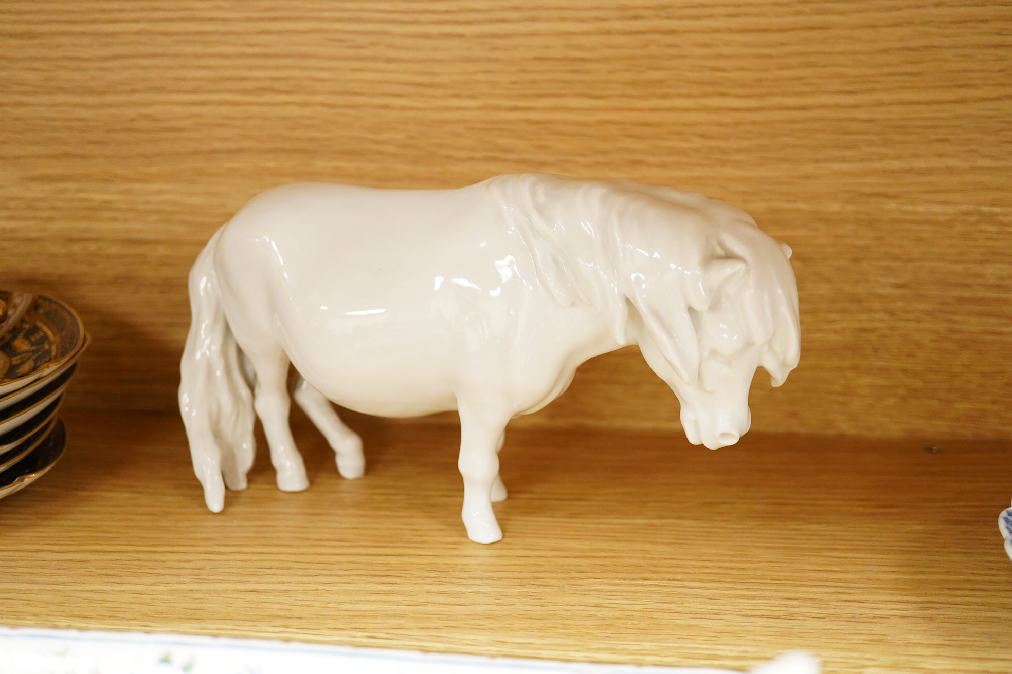 A collection of Coalport porcelain to include cups and saucers, a Meissen Pony, Meissen blue and white plate and a 19th century desk stand, largest 25cm wide